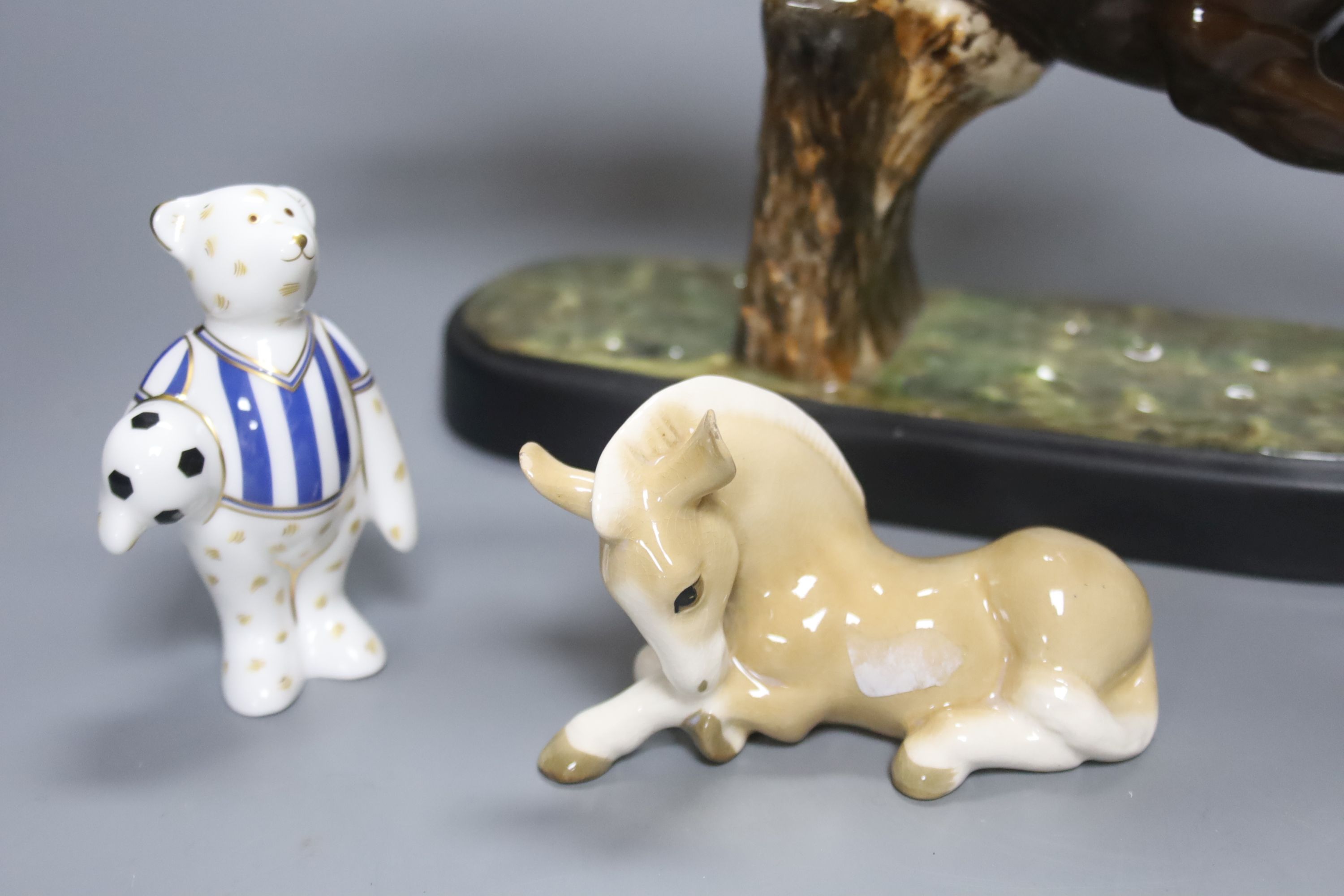 A Beswick racehorse and jockey, height 22cm, a Beswick child playing piano, a Royal Crown Derby bear footballer and a Continental earth